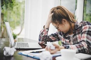 Young frustrated woman working at office photo