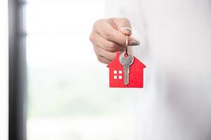 Close up portrait hand of asian woman hold show keys photo