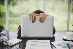 Tired businesswoman working on a computer photo