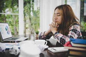 Tired businesswoman working on a computer photo