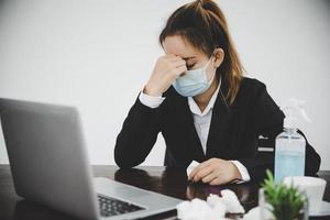 Sick young asian business woman wearing protective face mask photo