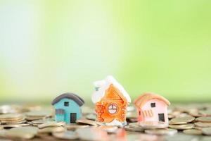 house with coins on bokeh background photo