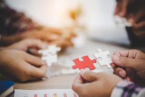 Business people and puzzle on wooden table photo