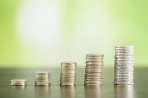 stack coins on green bokeh photo