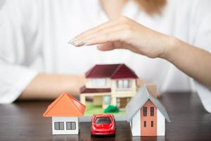 young woman use left hand to protect house model photo