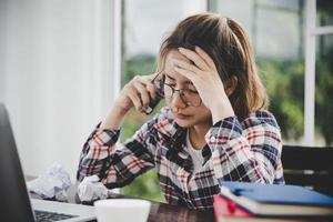 Tired businesswoman working on a computer photo