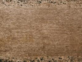 An old wooden plank table with a mottled surface and a pattern. photo