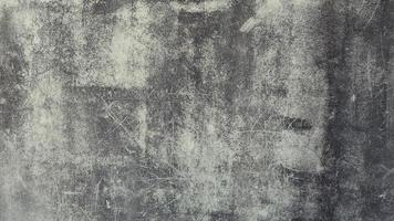 The old cement wall was weathered, the surface was scratched, the surface was scratched and damaged. For a mysterious retro-conservative background. photo