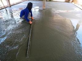 Plasterers are using equipment to smooth the plaster. photo