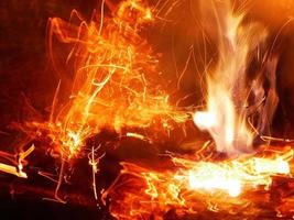 A beautiful flame shaped as imagined. like from hell, showing a dangerous and fiery fervor, black background photo