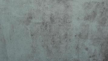The old cement wall was weathered, the surface was scratched, the surface was scratched and damaged. For a mysterious retro-conservative background. photo