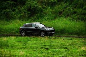 CHISINAU, MOLDOVA - JUNE 17, 2021, Porsche Macan S in off-road racing full of mood on bad road in Moldova. Editorial photo. photo