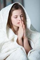 Girl sleeps in a white bed at home. Young woman sleeping in sleepwear on the white linen in bed at home, top view. photo