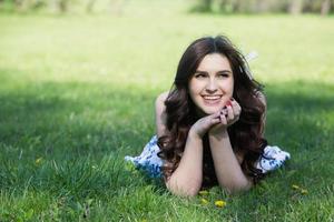 beautiful white european girl with clean skin in the park with flowering trees photo