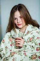 Girl sleeps in a white bed at home. Young woman sleeping in sleepwear on the white linen in bed at home, top view. photo