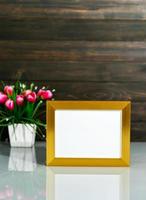 Picture mock up with golden frame on table photo