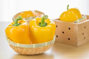 Fresh yellow bell peppers in basket photo