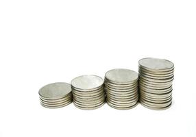 Stacked silver metal coins Step by step A white background gives the idea of growth. Financial business, saving money, interest, gives a feeling of wealth and security in life. photo