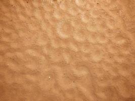 The red sand pattern looks like a hole.  Caused by natural raindrops, used as a background, wallpaper and design. photo