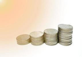 Stacked silver metal coins Step by step A white background gives the idea of growth. Financial business, saving money, interest, gives a feeling of wealth and security in life. photo