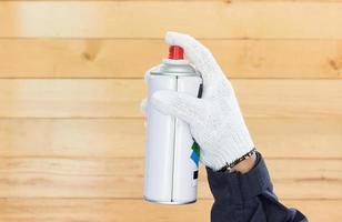 Hand holding spray paint can photo