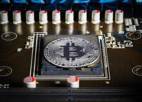 Cryptocurrency bitcoin silver coins on circuit board photo