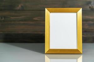 Picture golden frame mock up on table photo