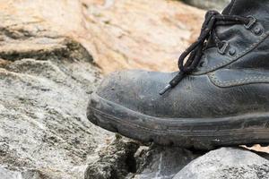 Trekking leather boot on the rock photo