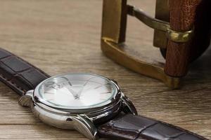 Wristwatch and brown leather belt photo