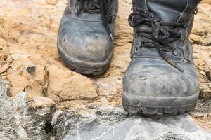 Trekking leather boot on the rock photo