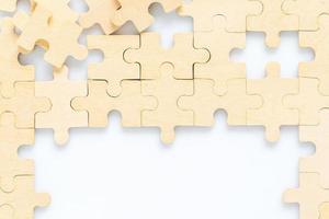 wooden jigsaw puzzle pieces on white background photo