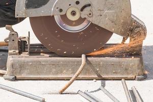 Worker cutting metal with grinder photo