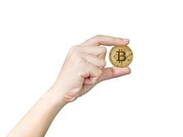 Woman holding some pieces of golden Bitcoin token photo