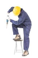 Handyman standing with his electric drill with clipping path photo