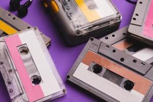 Cassette player and cassette tapes on purple background. photo