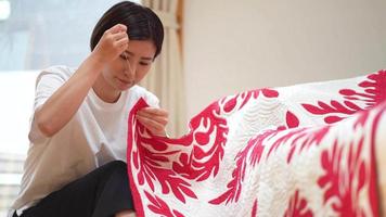 A woman making a Hawaiian quilt video