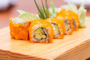Sushi, japanese food, california rolls on wooden plate. photo