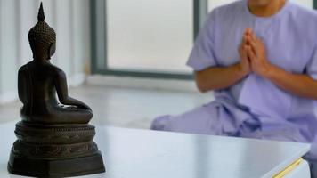 Asian Buddhist man praying to the Buddha image. photo