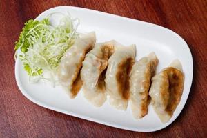 Japanese food. Gyoza. Meat and vegetables are wrapped in flour and then fried or steamed. photo