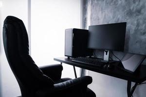 Black computer and tablet on the desk. photo