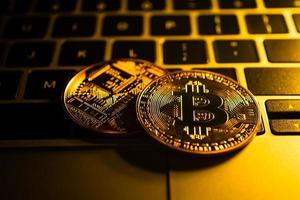 Golden coins with bitcoin symbol on computer. photo