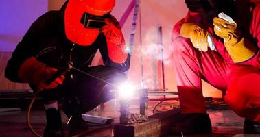 Male welders working together at site. photo