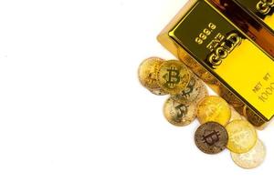 Bitcoins of new digital money and gold bars on white background photo