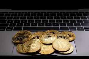 Golden coins with bitcoin symbol on computer. photo