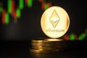 Stack of golden coins with ethereum symbol with stock graph background. photo