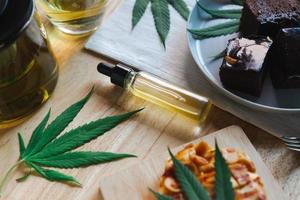 Food and drink and cannabis oil on the dining table. Alternative medicine concept. photo