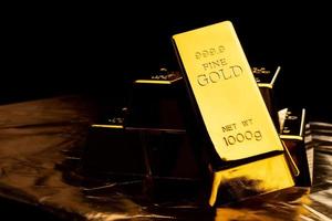 Close up of gold bars on black bacground. financial concept photo