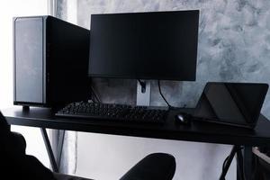 Black computer and tablet on the desk. photo