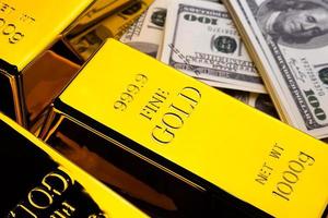 Close up of Gold bars and banknotes. financial concept photo