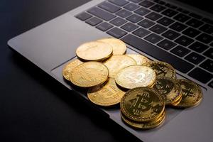Golden coins with bitcoin symbol on computer. photo